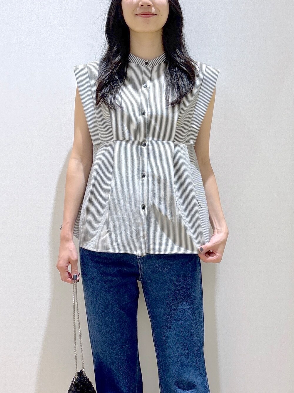 ホワイト系のシャツ/ブラウス、ブルー系のデニムパンツ、ブラック系のショルダーバッグを着用したレディースの夏コーディネートの5枚目の写真