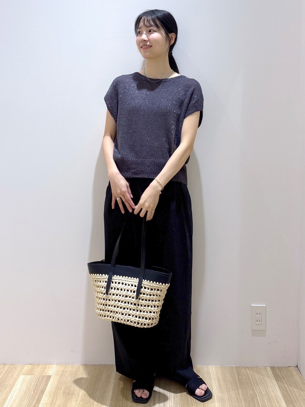 グレー系のニット/セーター、ブラック系のその他パンツ、ブラック系のトートバッグを着用したレディースの夏コーディネートの8枚目の写真