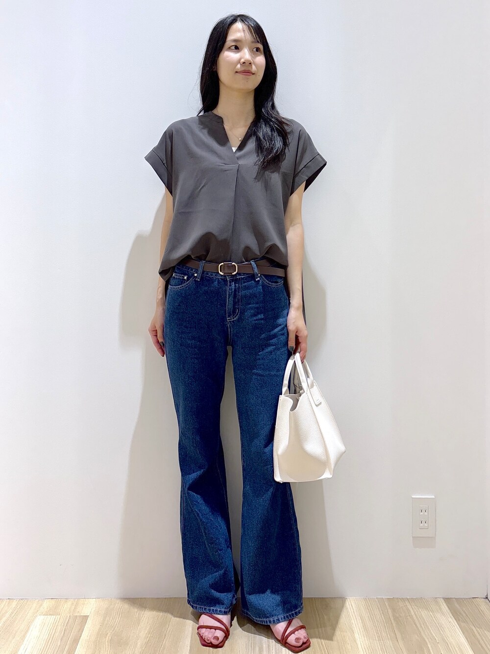 ブルー系のデニムパンツ、ホワイト系のショルダーバッグ、レッド系のサンダルを着用したレディースの夏コーディネートの9枚目の写真