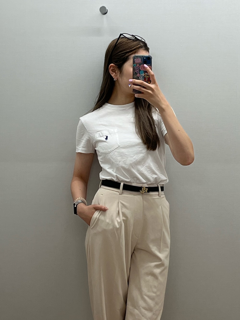 ホワイト系のTシャツ/カットソー、ブラック系のスラックス、ブラック系のベルトを着用したレディースの冬コーディネートの2枚目の写真