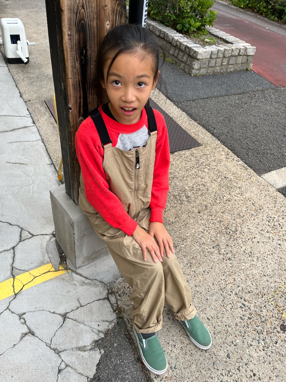 ベージュ系のサロペット/オーバーオール、グリーン系のスリッポン、グレー系のスウェットを着用したキッズの秋コーディネートの2枚目の写真