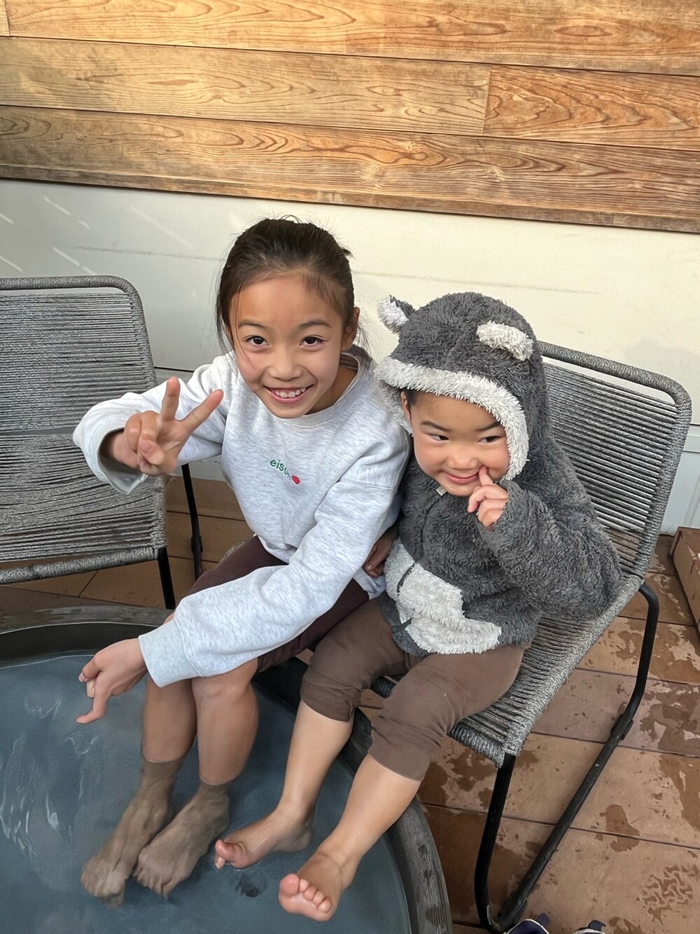 グレー系のスウェット、ベージュ系のスニーカー、ブラウン系のレギンス/スパッツを着用したキッズの冬コーディネートの2枚目の写真