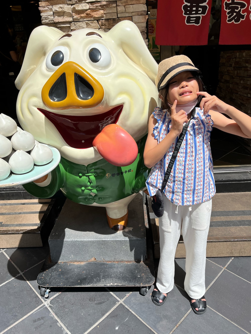 ベージュ系のハット、ブルー系の水着、ブラック系のラッシュガードを着用したキッズの夏コーディネートの3枚目の写真