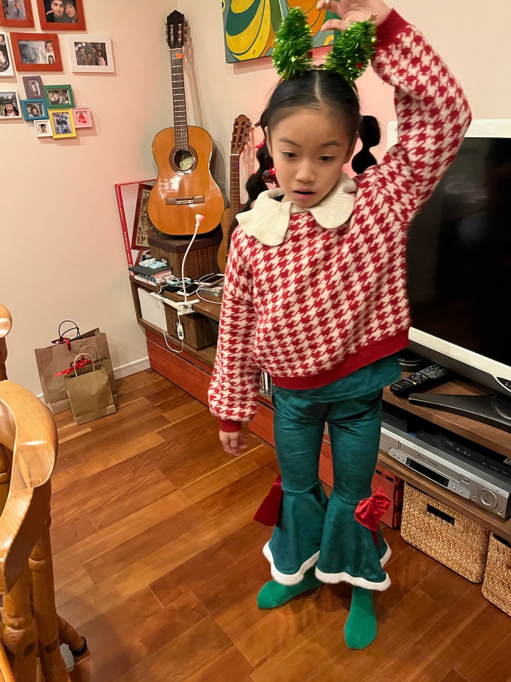 ブラック系のチェスターコート、ホワイト系のニット/セーター、グリーン系のスニーカーを着用したキッズの冬コーディネートの2枚目の写真