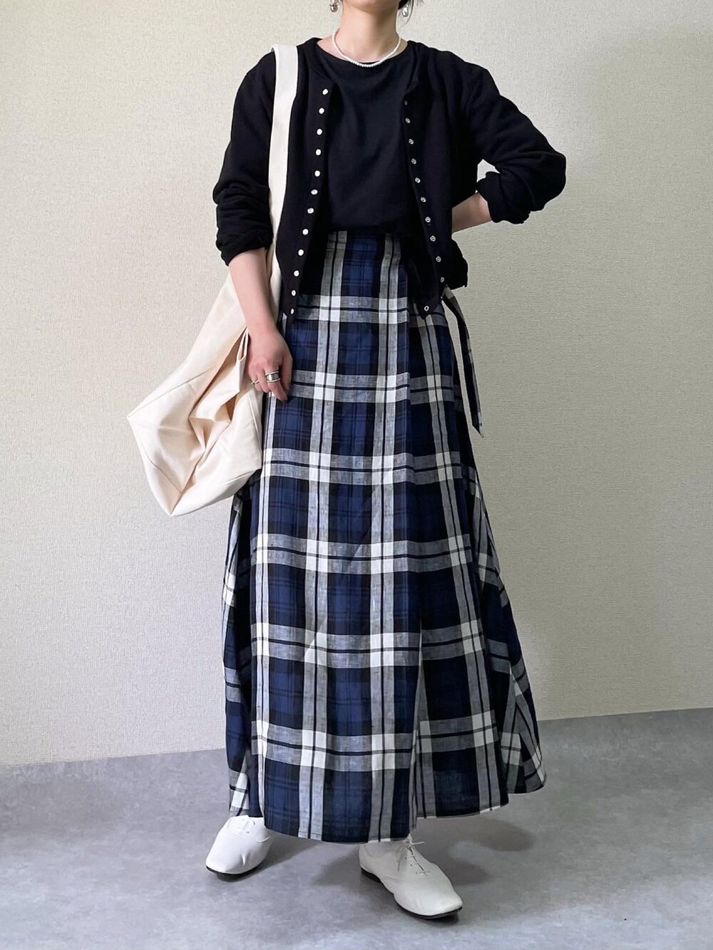 ホワイト系のバッグ、ブラック系のカーディガン/ボレロ、ブラック系のTシャツ/カットソーを着用したレディースの春コーディネートの2枚目の写真