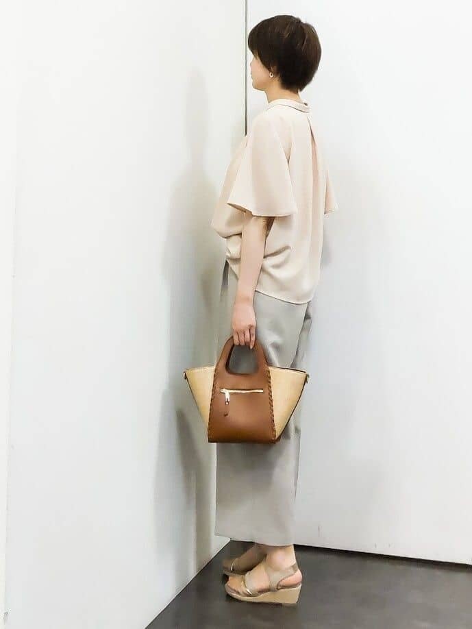 ピンク系のシャツ/ブラウス、ベージュ系のその他パンツ、イエロー系のトートバッグを着用したレディースの春コーディネートの2枚目の写真