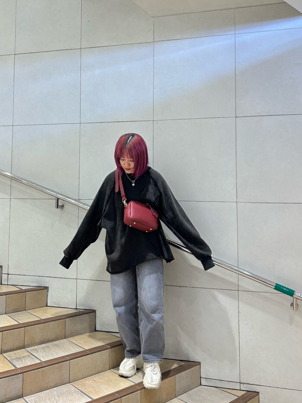 グレー系のデニムパンツ、ブラック系のTシャツ/カットソーを着用したレディースの秋コーディネートの2枚目の写真