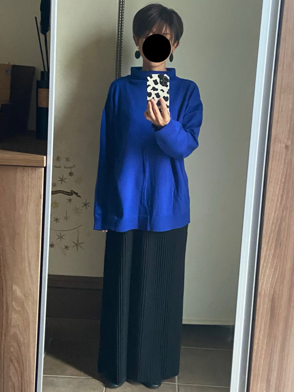 ブルー系のニット/セーター、ブラック系のスカート、ブラック系のバレエシューズを着用したレディースの秋コーディネートの3枚目の写真