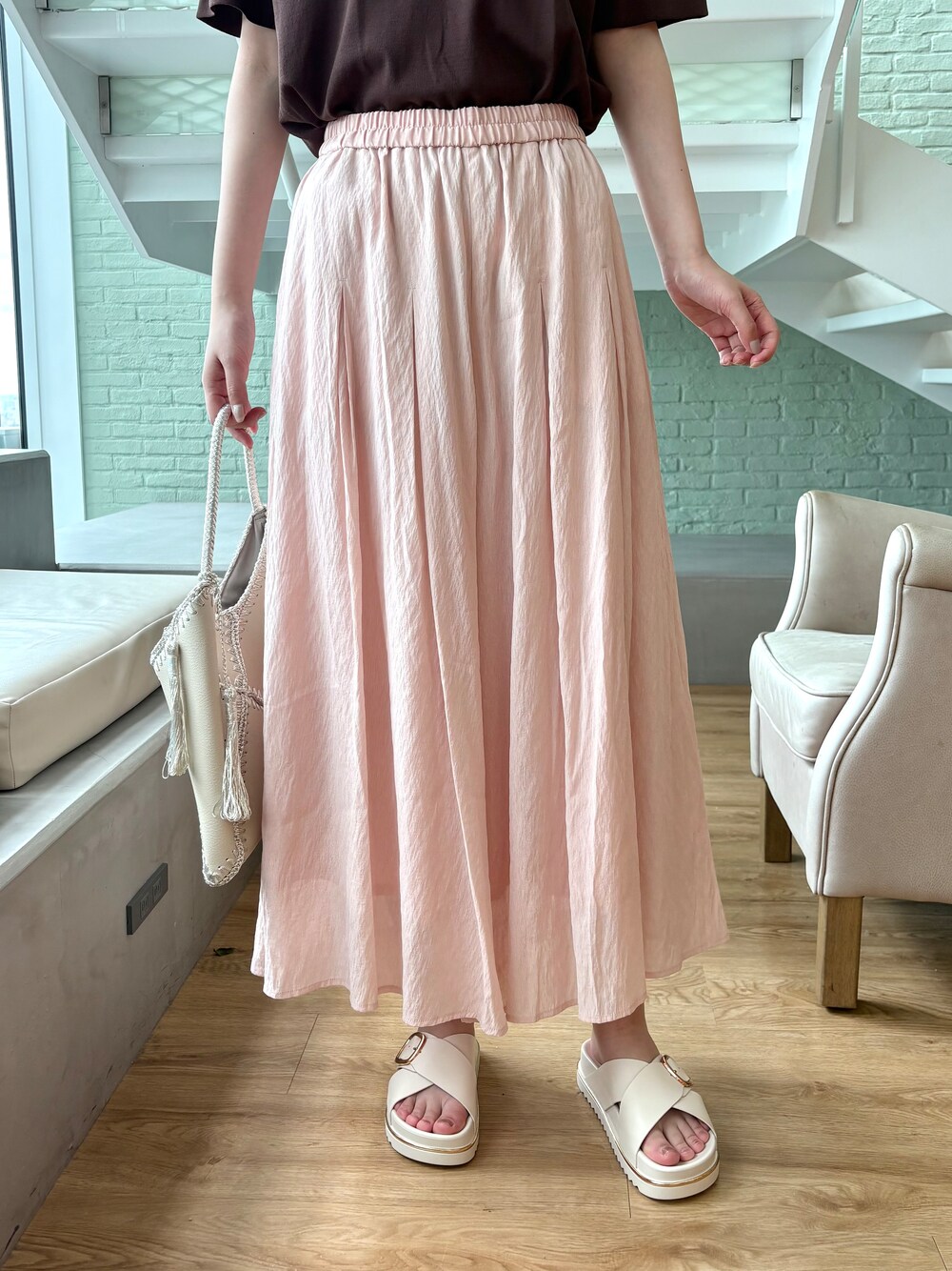ブラウン系のニット/セーター、ピンク系のその他パンツ、ホワイト系のハンドバッグを着用したレディースの春コーディネートの9枚目の写真