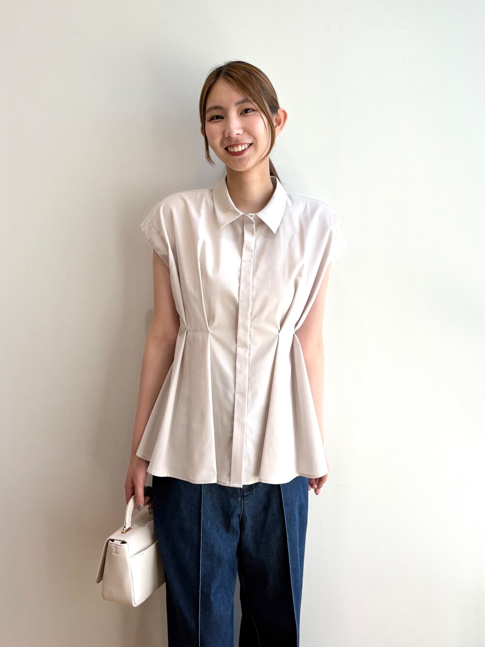 ベージュ系のシャツ/ブラウス、ブルー系のデニムパンツ、ホワイト系のショルダーバッグを着用したレディースの夏コーディネートの9枚目の写真
