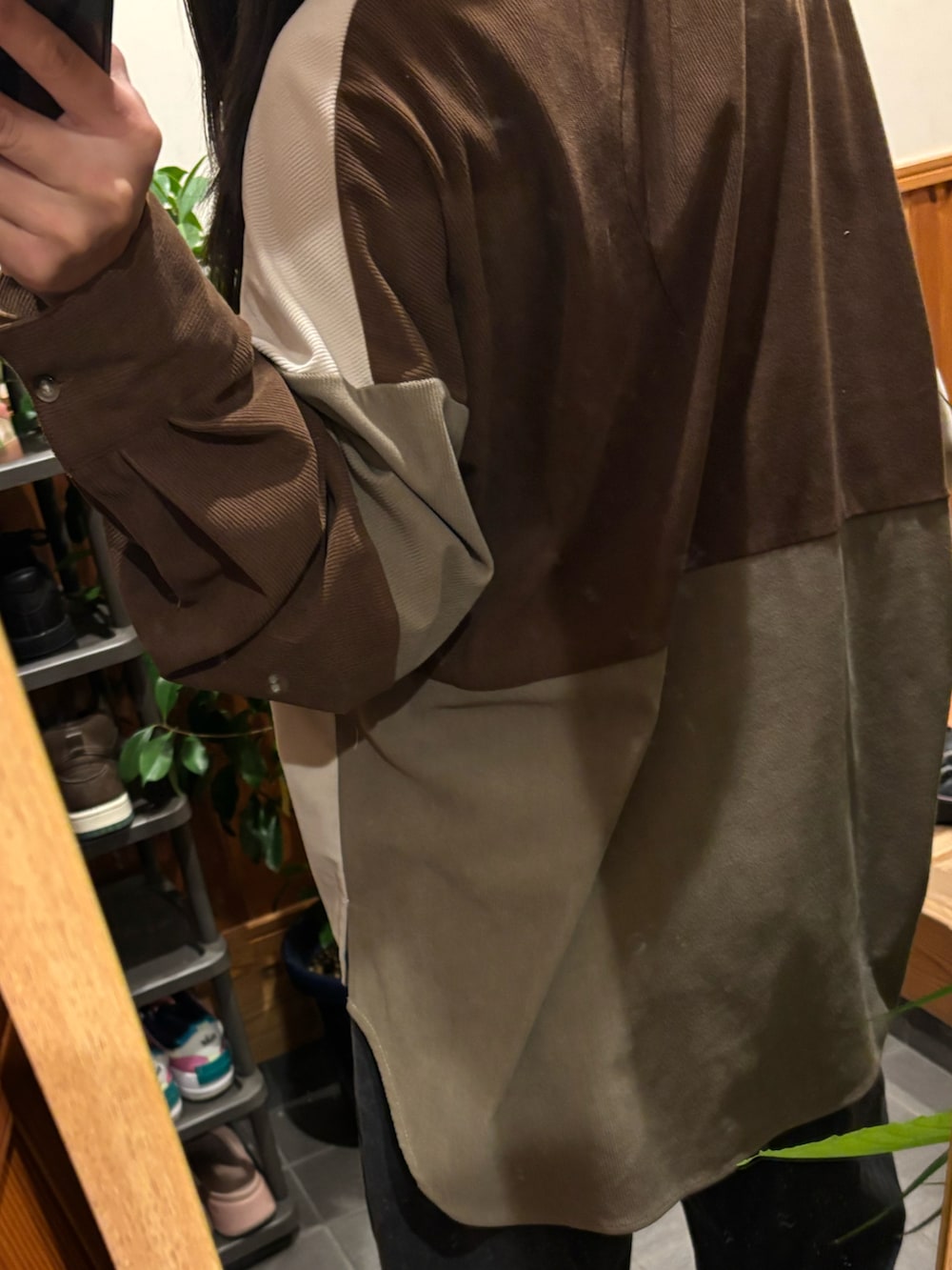 グレー系のデニムパンツ、ブラウン系のシャツ/ブラウス、ブラック系のスニーカーを着用したレディースの秋コーディネートの2枚目の写真