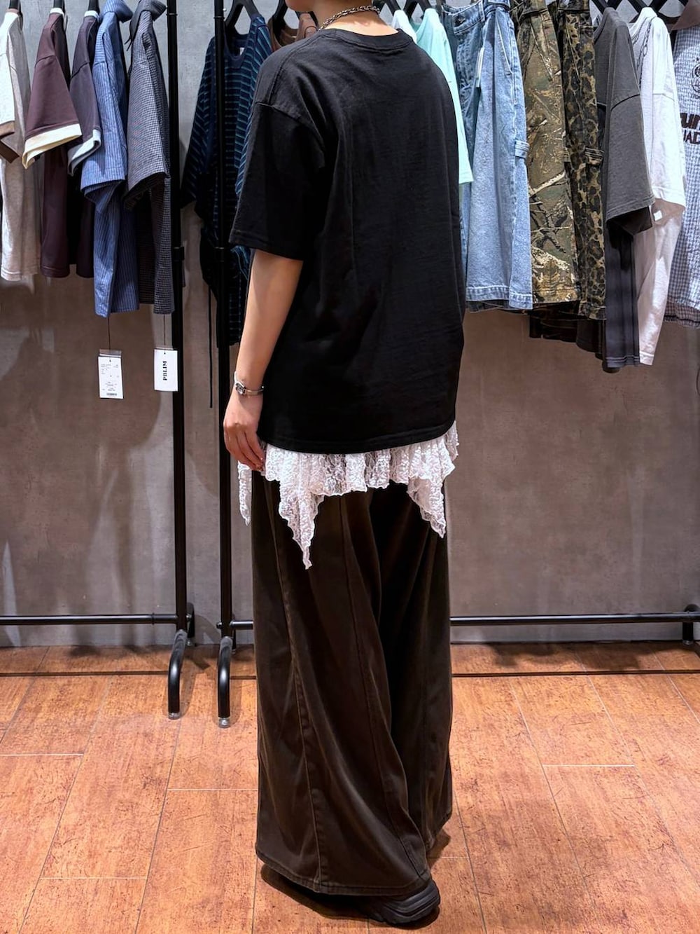 ブラウン系のデニムパンツ、ブラック系のTシャツ/カットソー、ブラック系のブーツを着用したレディースの夏コーディネートの5枚目の写真