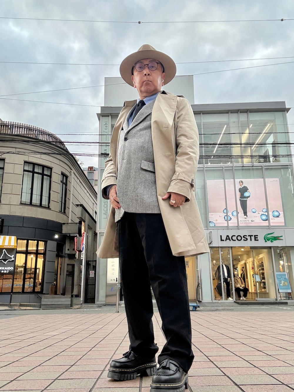 ブルー系のシャツ/ブラウス、ブラック系のネクタイ、グレー系のテーラードジャケットを着用したメンズの冬コーディネートの2枚目の写真