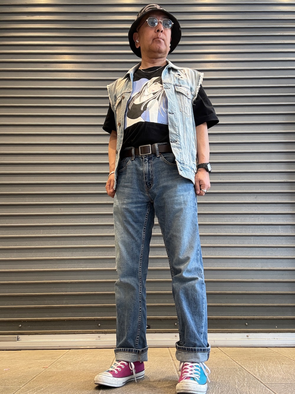 ブルー系のベスト、ブラック系のTシャツ/カットソー、ブルー系のデニムパンツを着用したメンズの春コーディネートの2枚目の写真