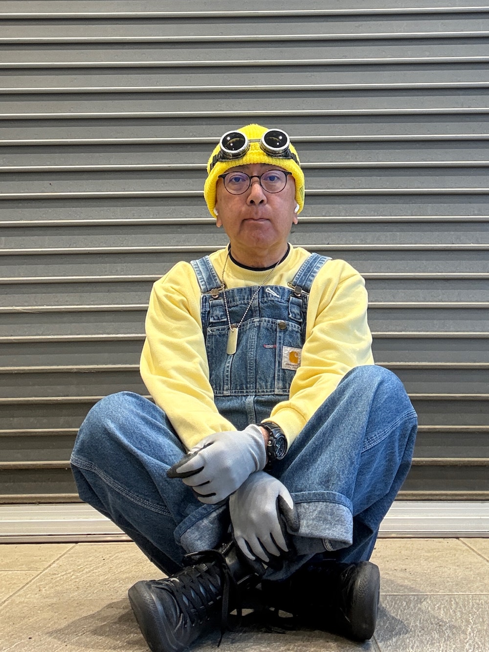 ブルー系のサロペット/オーバーオール、イエロー系のスウェット、ブラック系のスニーカーを着用したメンズの春コーディネートの3枚目の写真