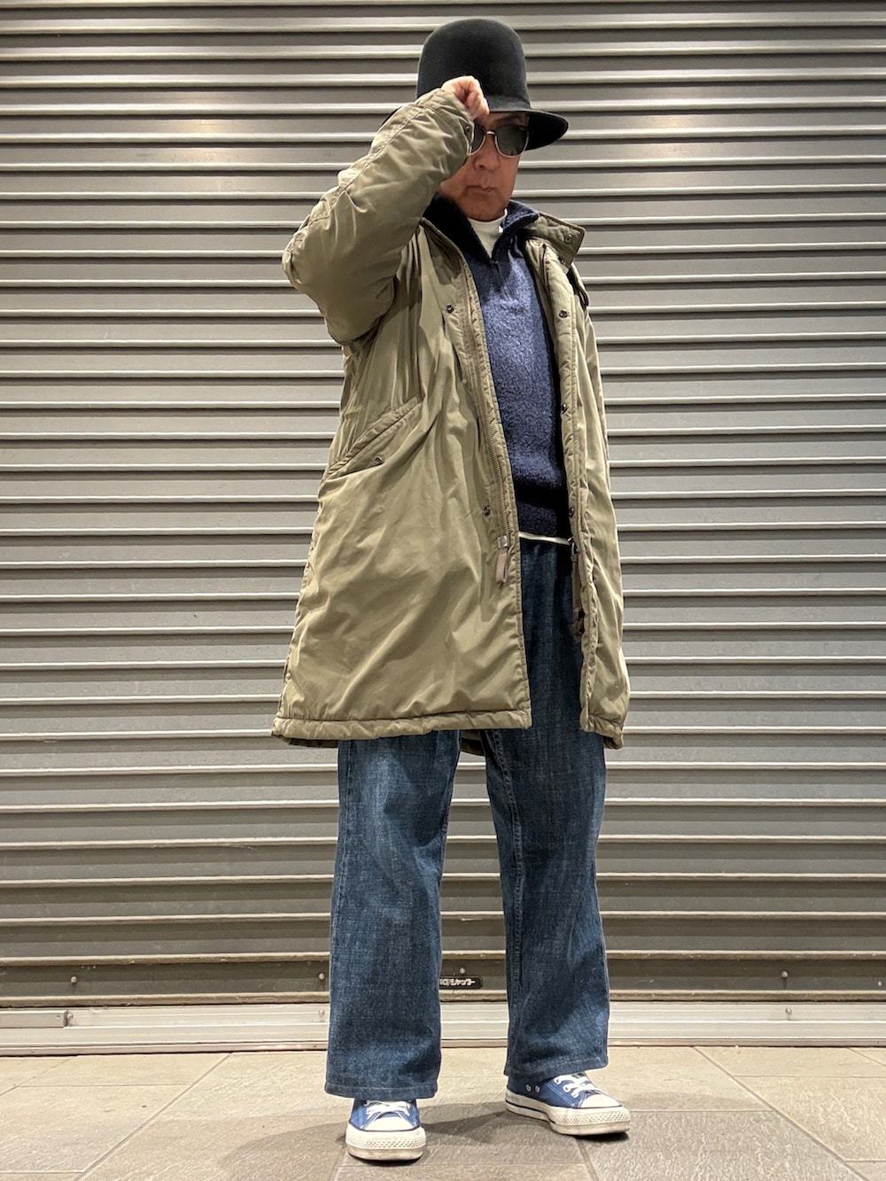 ホワイト系のTシャツ/カットソー、グリーン系のモッズコート、ブルー系のニット/セーターを着用したメンズの冬コーディネートの2枚目の写真