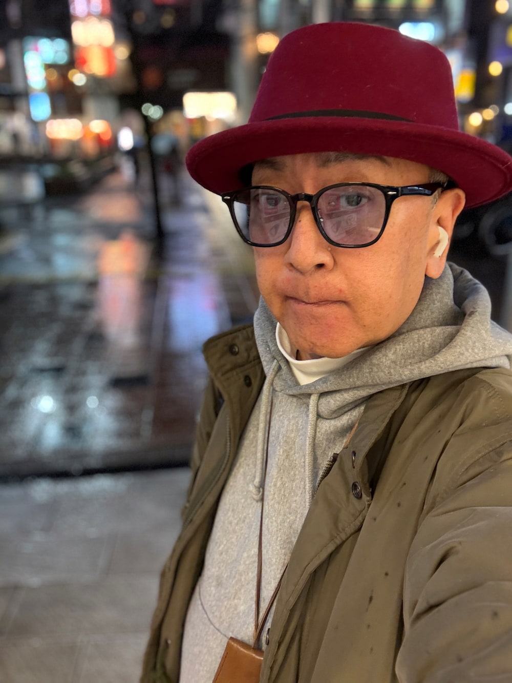 ホワイト系のTシャツ/カットソー、グレー系のパーカー、グリーン系のモッズコートを着用したメンズの冬コーディネートの3枚目の写真