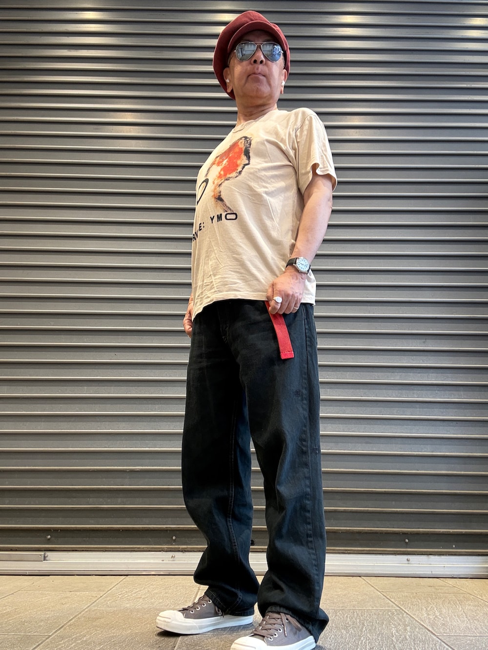 ベージュ系のTシャツ/カットソー、ブラック系のデニムパンツ、ベージュ系のスニーカーを着用したメンズの春コーディネートの2枚目の写真