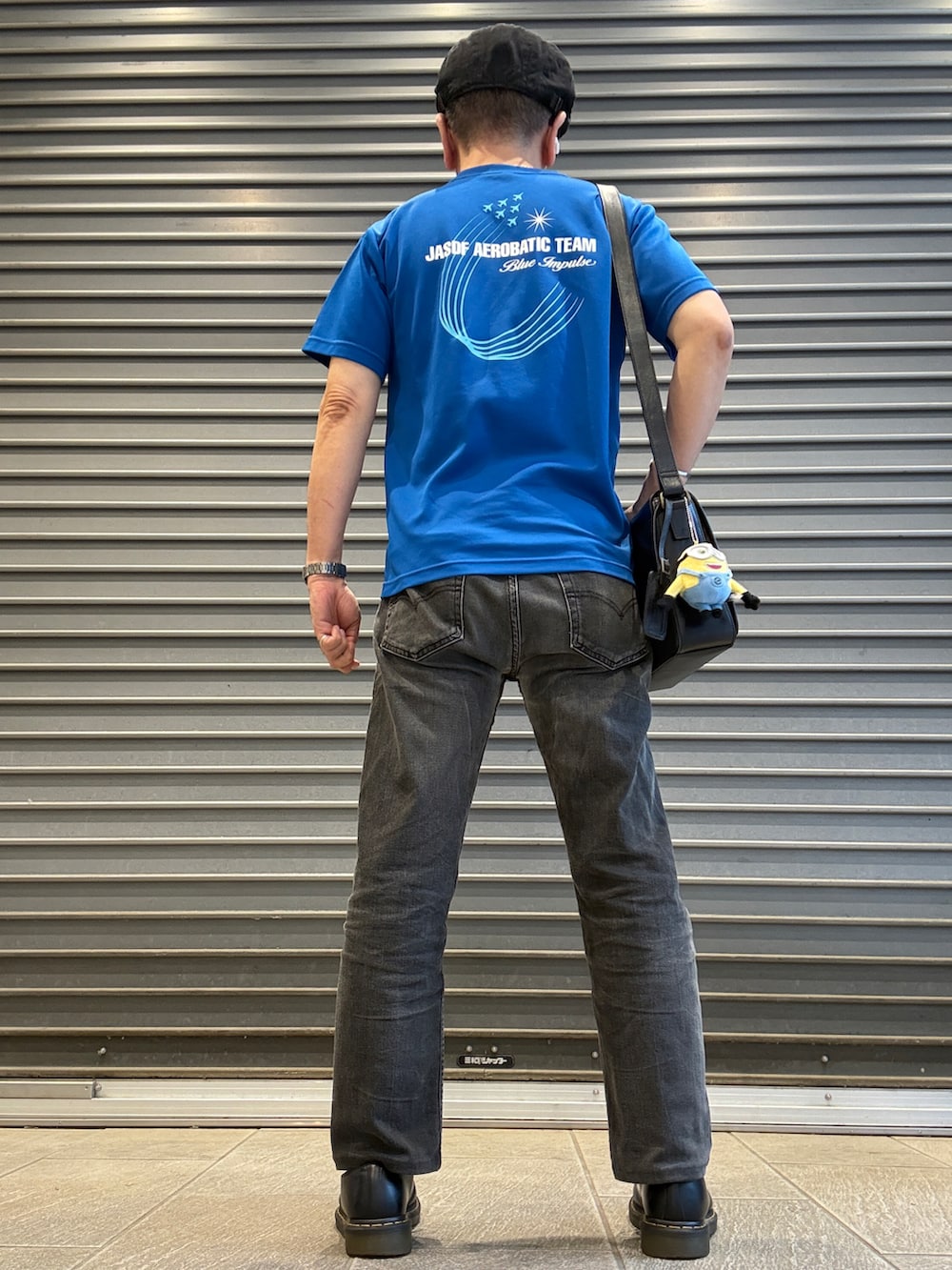 ブラック系のドレスシューズ、ブルー系のTシャツ/カットソー、ブラック系のデニムパンツを着用したメンズの夏コーディネートの2枚目の写真