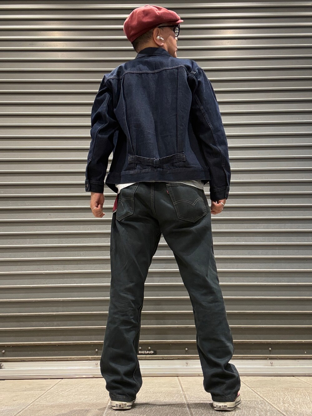 レッド系のスニーカー、グレー系のTシャツ/カットソー、ブルー系のデニムジャケットを着用したメンズの春コーディネートの3枚目の写真