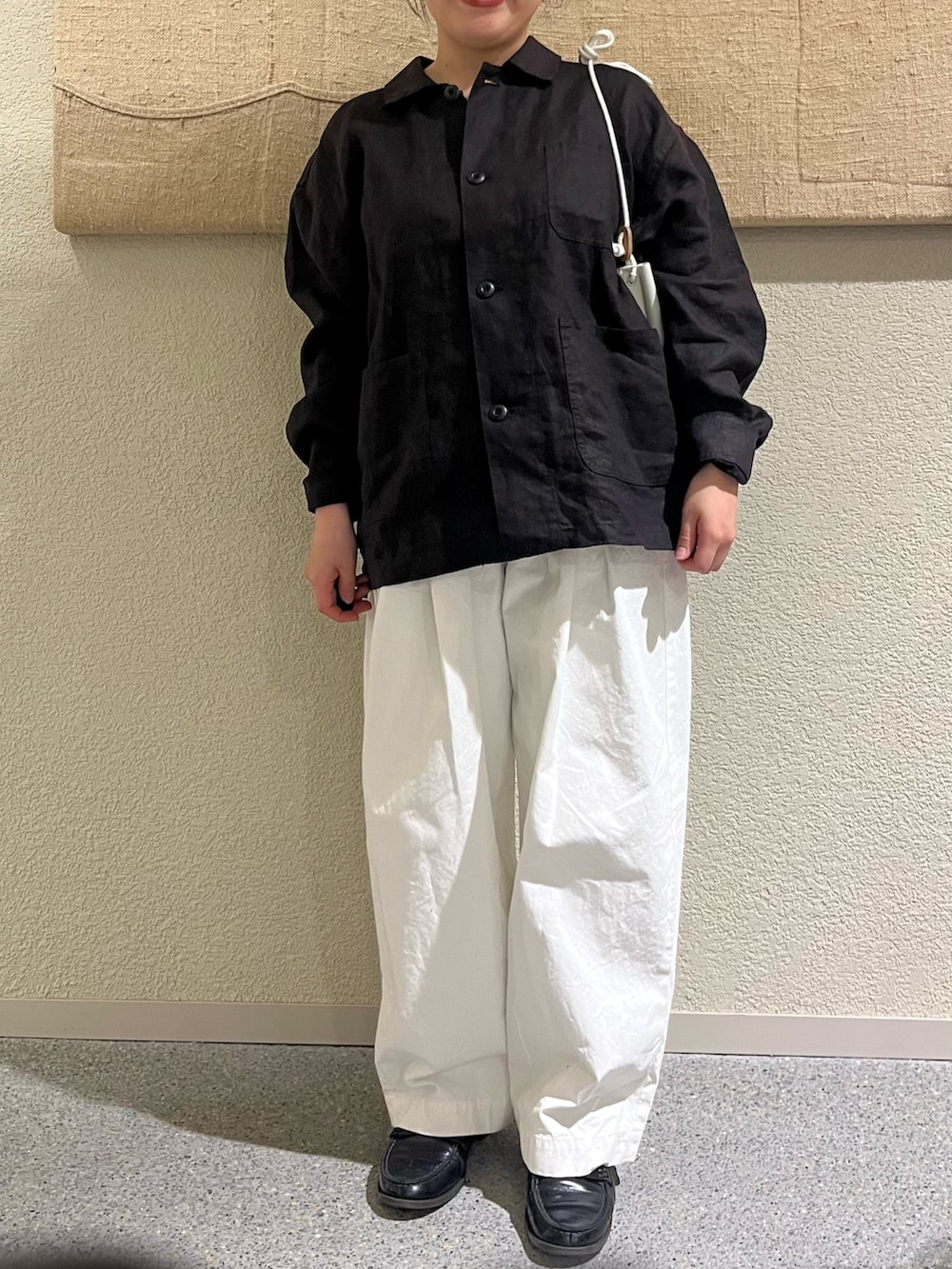 グレー系のカバーオール、ホワイト系のその他パンツ、ホワイト系のショルダーバッグを着用したレディースの春コーディネートの6枚目の写真