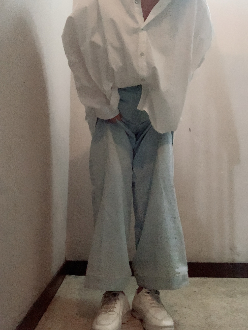 ブルー系のデニムパンツ、ホワイト系のスニーカー、ホワイト系のシャツ/ブラウスを着用したレディースの秋コーディネートの3枚目の写真