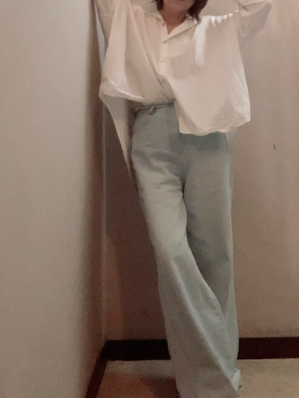 ブルー系のデニムパンツ、ホワイト系のスニーカー、ホワイト系のシャツ/ブラウスを着用したレディースの秋コーディネートの4枚目の写真