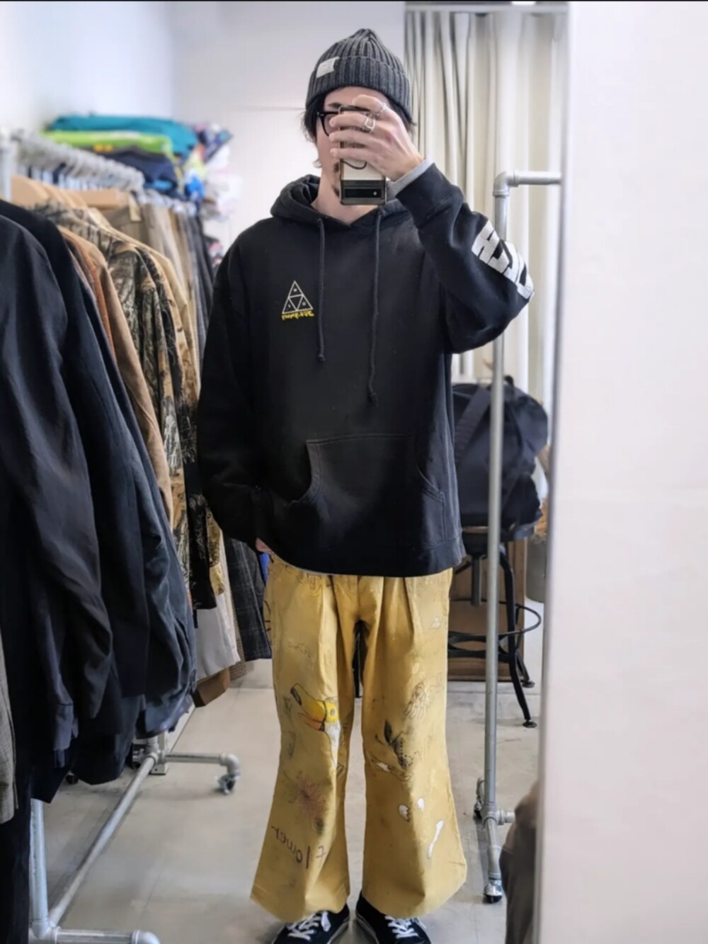 グリーン系のその他アウター、ベージュ系のその他パンツ、ブラック系のスニーカーを着用したメンズの春コーディネートの2枚目の写真