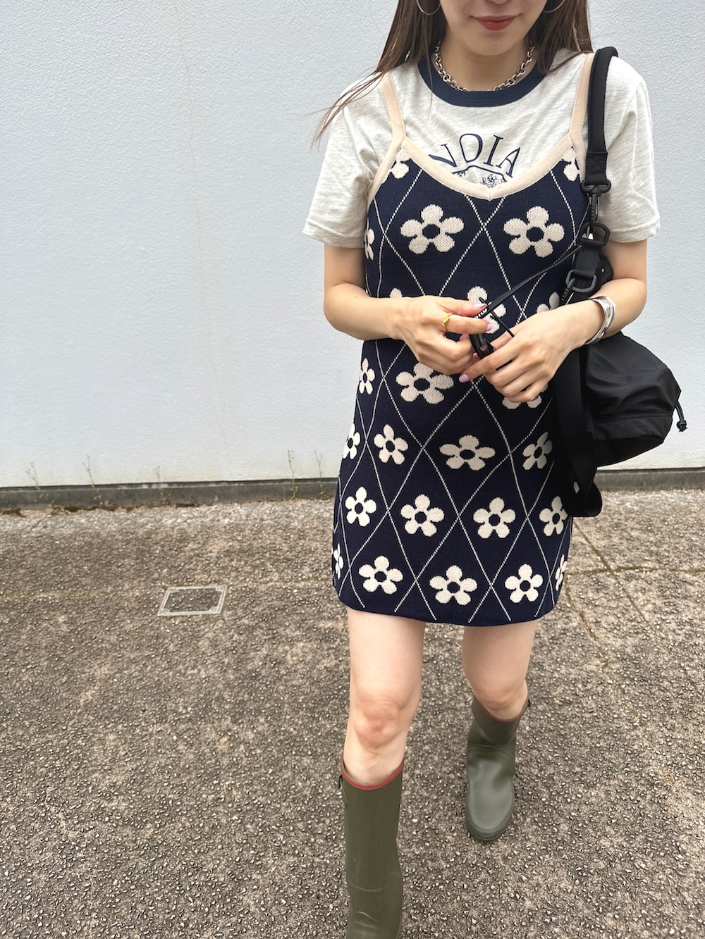 ブラック系のバッグ、ブルー系のワンピース/ドレス、ベージュ系のレインシューズを着用したレディースの春コーディネートの2枚目の写真