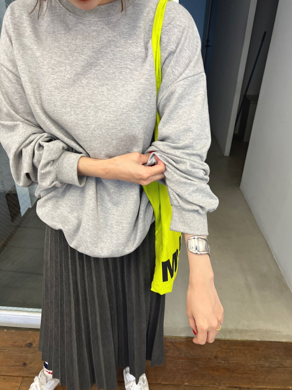 グレー系のスカート、グレー系のスウェット、ブルー系のマフラーを着用したレディースの冬コーディネートの5枚目の写真