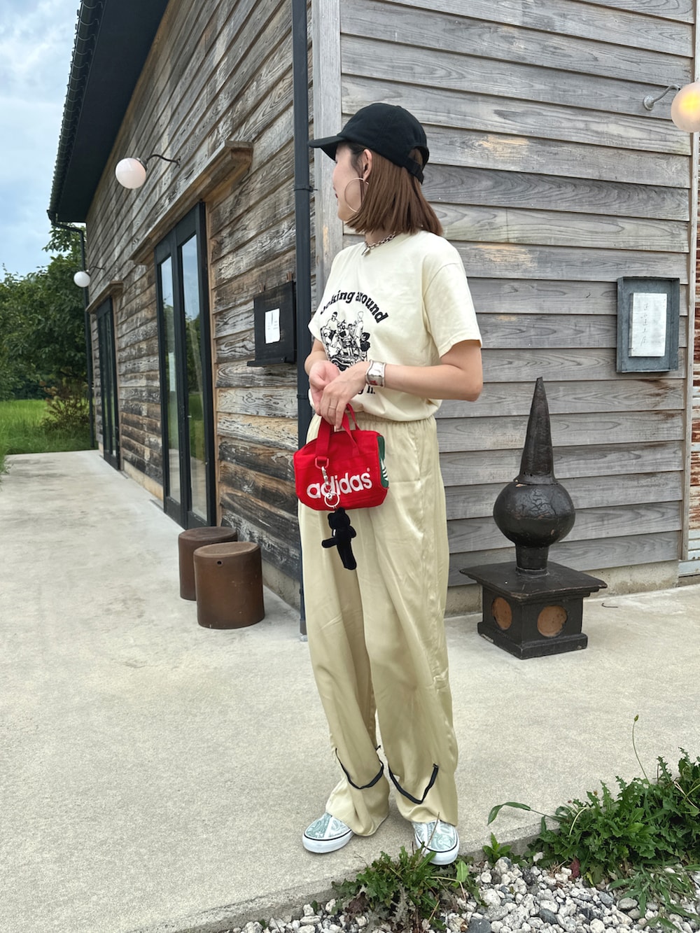 イエロー系のTシャツ/カットソー、ベージュ系のパンツ、グリーン系のシューズを着用したレディースの夏コーディネートの2枚目の写真