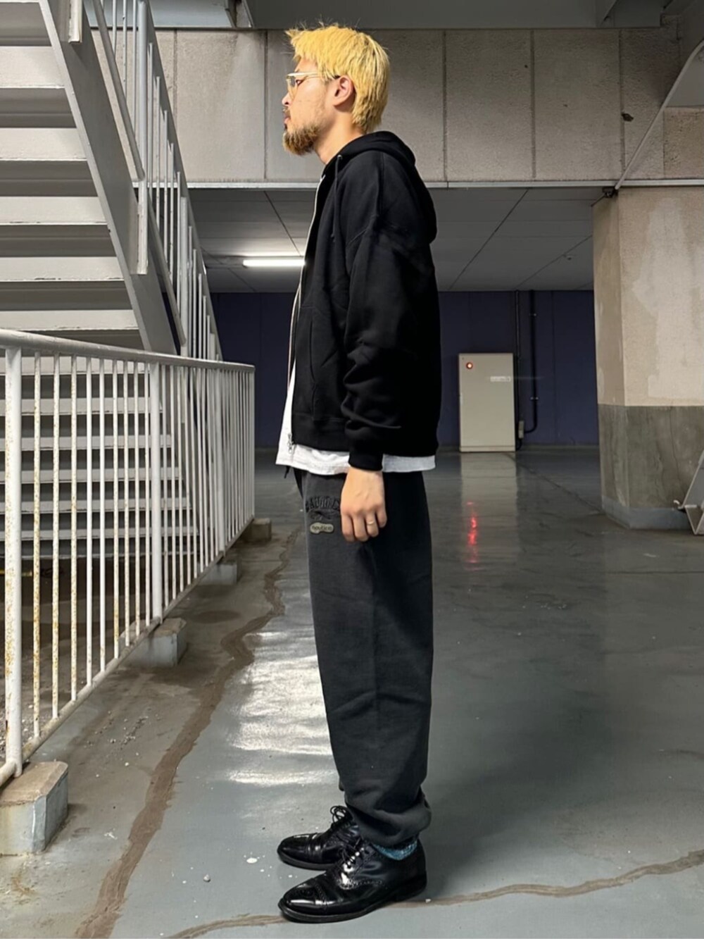 ブラック系のパーカー、ブラック系のスウェットパンツを着用したメンズの秋コーディネートの2枚目の写真