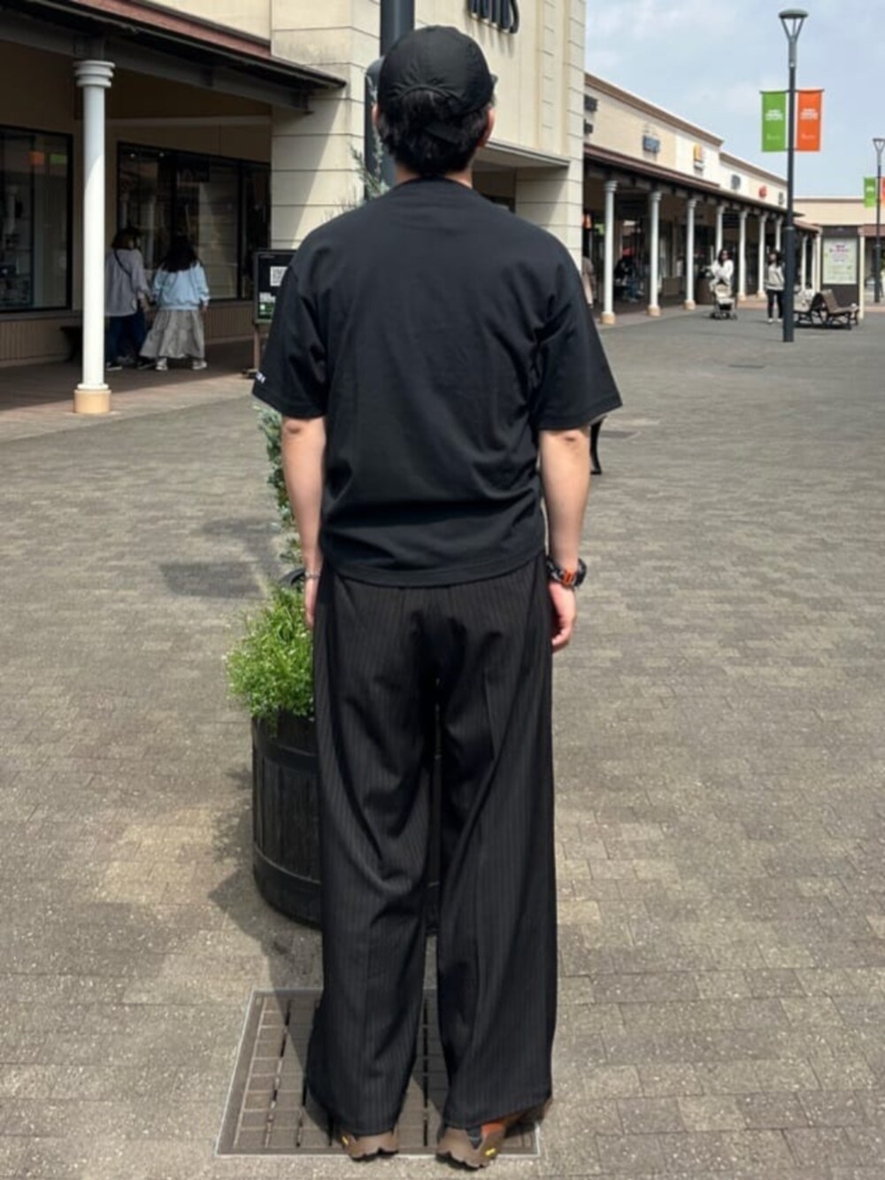 ブラック系のTシャツ/カットソー、その他のスラックスを着用したメンズの春コーディネートの2枚目の写真