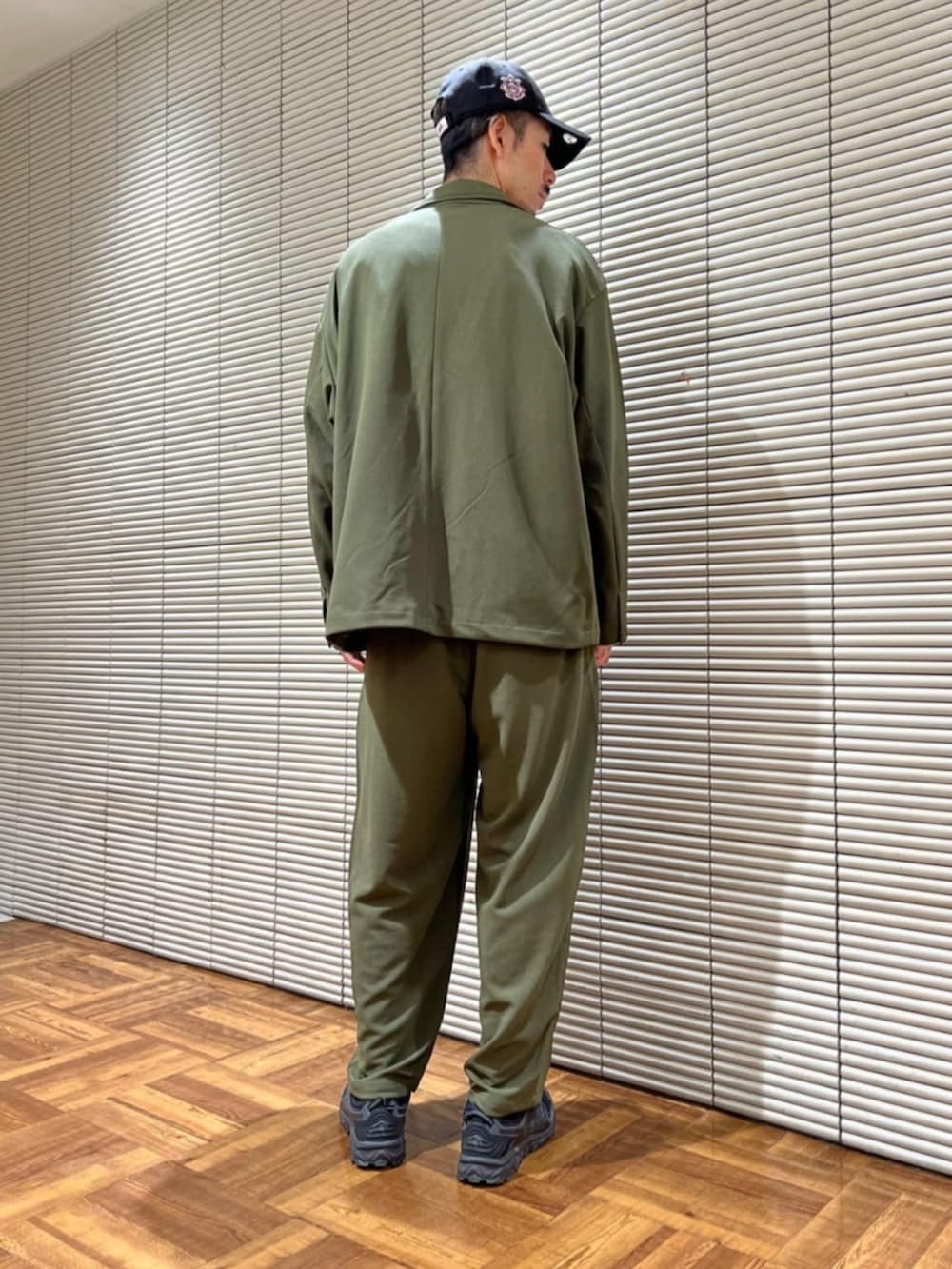 グリーン系のセットアップを着用したメンズの夏コーディネートの2枚目の写真