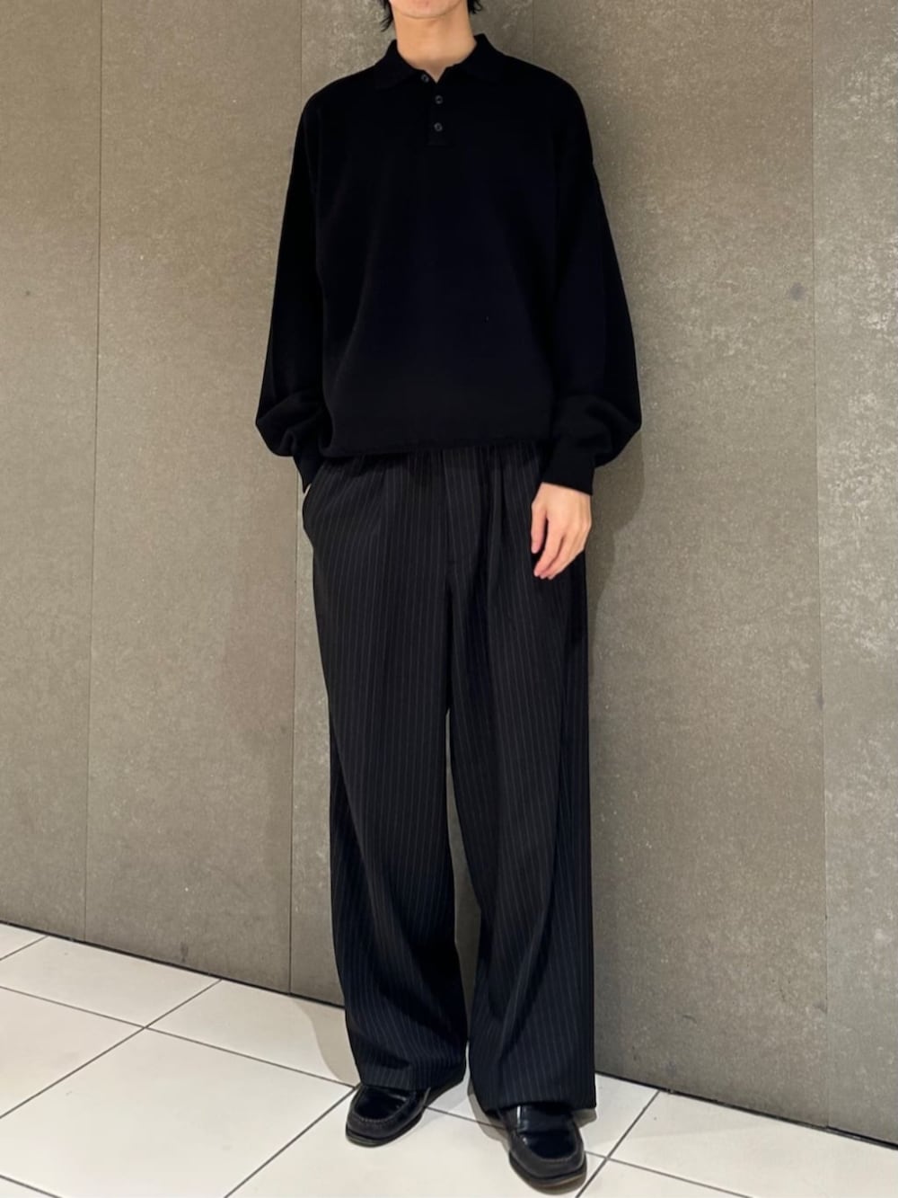 ブラック系のニット/セーター、ブラック系のスラックスを着用したメンズの秋コーディネートの2枚目の写真