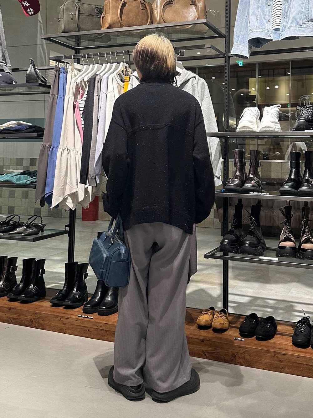 グレー系のデニムパンツ、ブルー系のショルダーバッグ、ブラック系のカーディガン/ボレロを着用したメンズの冬コーディネートの5枚目の写真