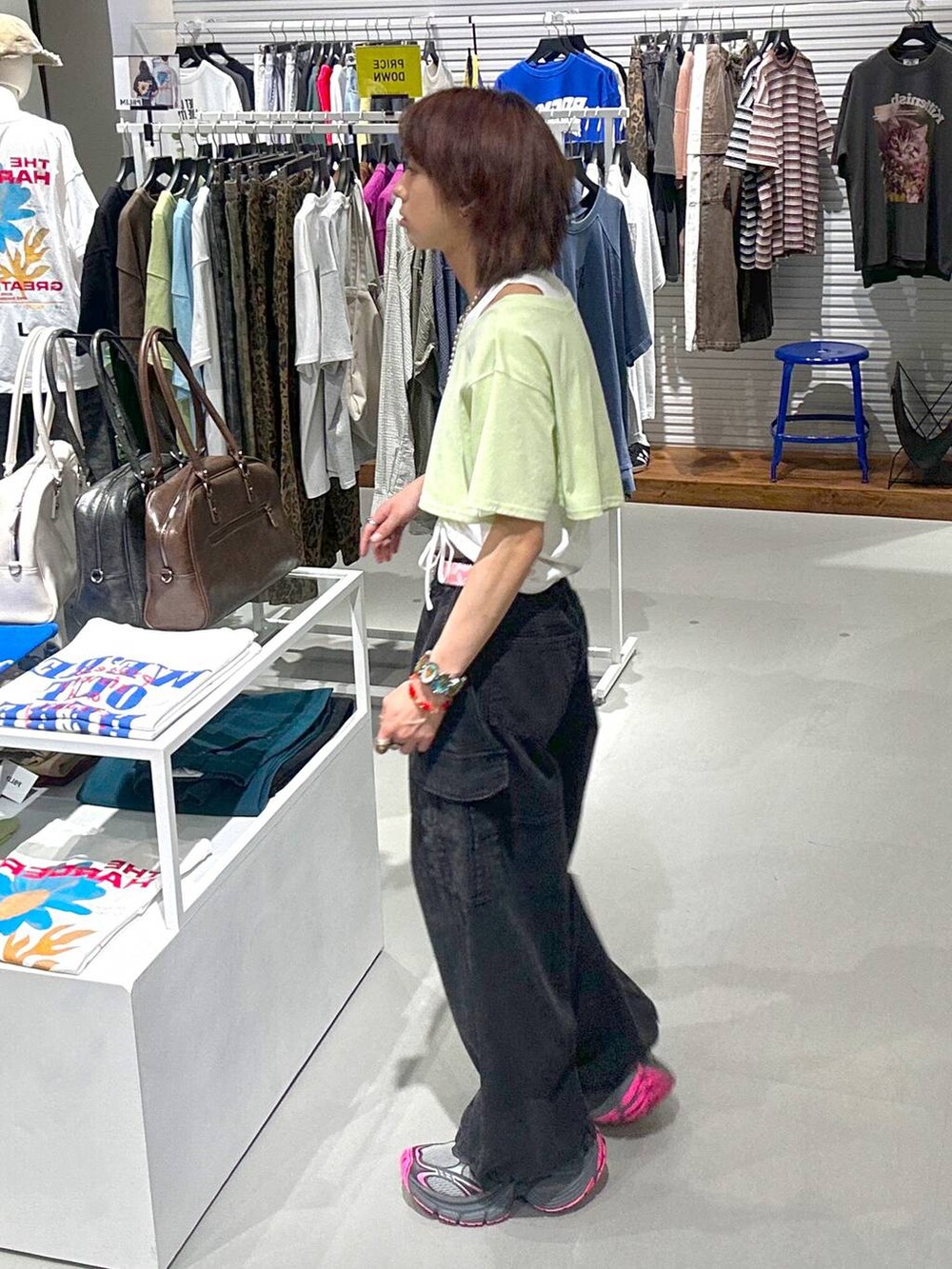 ブラック系のカーゴパンツ、グリーン系のTシャツ/カットソー、ブラック系のネックレスを着用したメンズの春コーディネートの4枚目の写真
