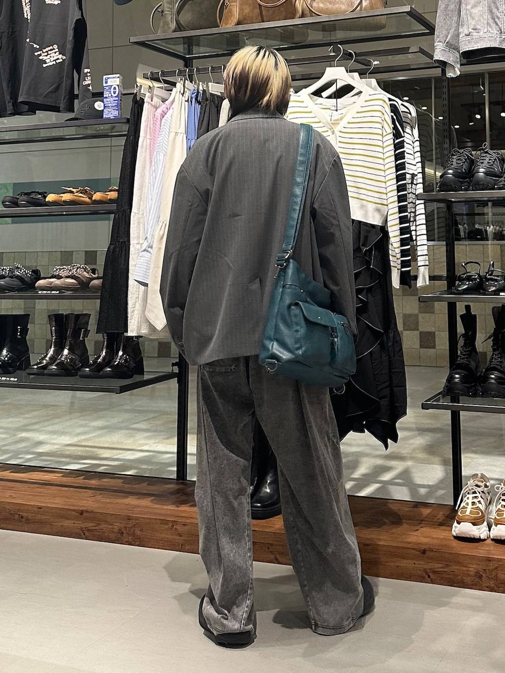 ブルー系のショルダーバッグ、ブラック系のデニムパンツ、ホワイト系のTシャツ/カットソーを着用したメンズの春コーディネートの5枚目の写真