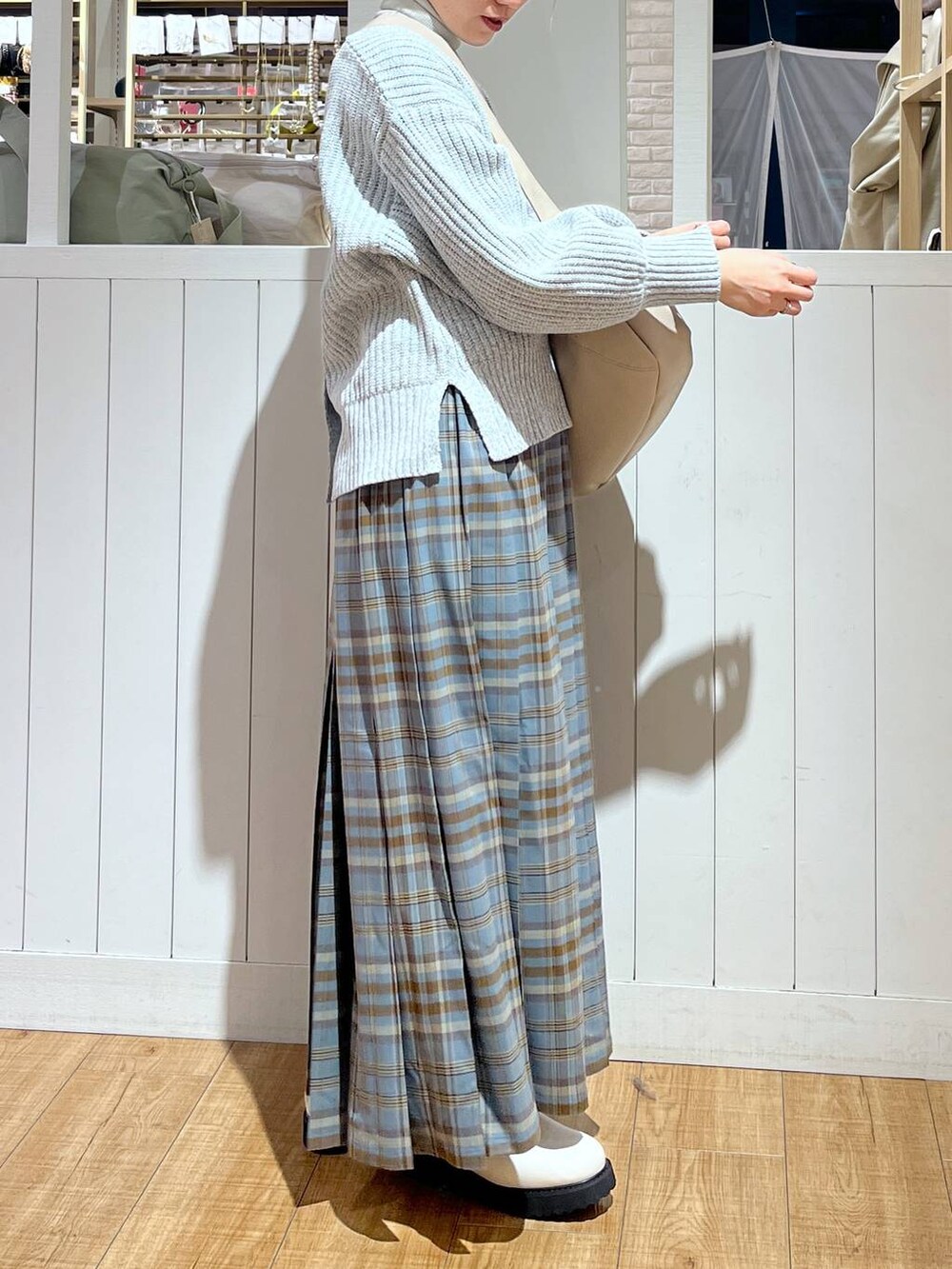 その他のスカート、ベージュ系のブーツ、ベージュ系のショルダーバッグを着用したレディースの冬コーディネートの3枚目の写真