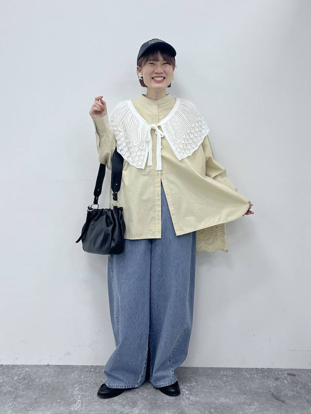 ブルー系のデニムパンツ、ブラック系のトートバッグ、ブラック系のローファーを着用したレディースの春コーディネートの4枚目の写真