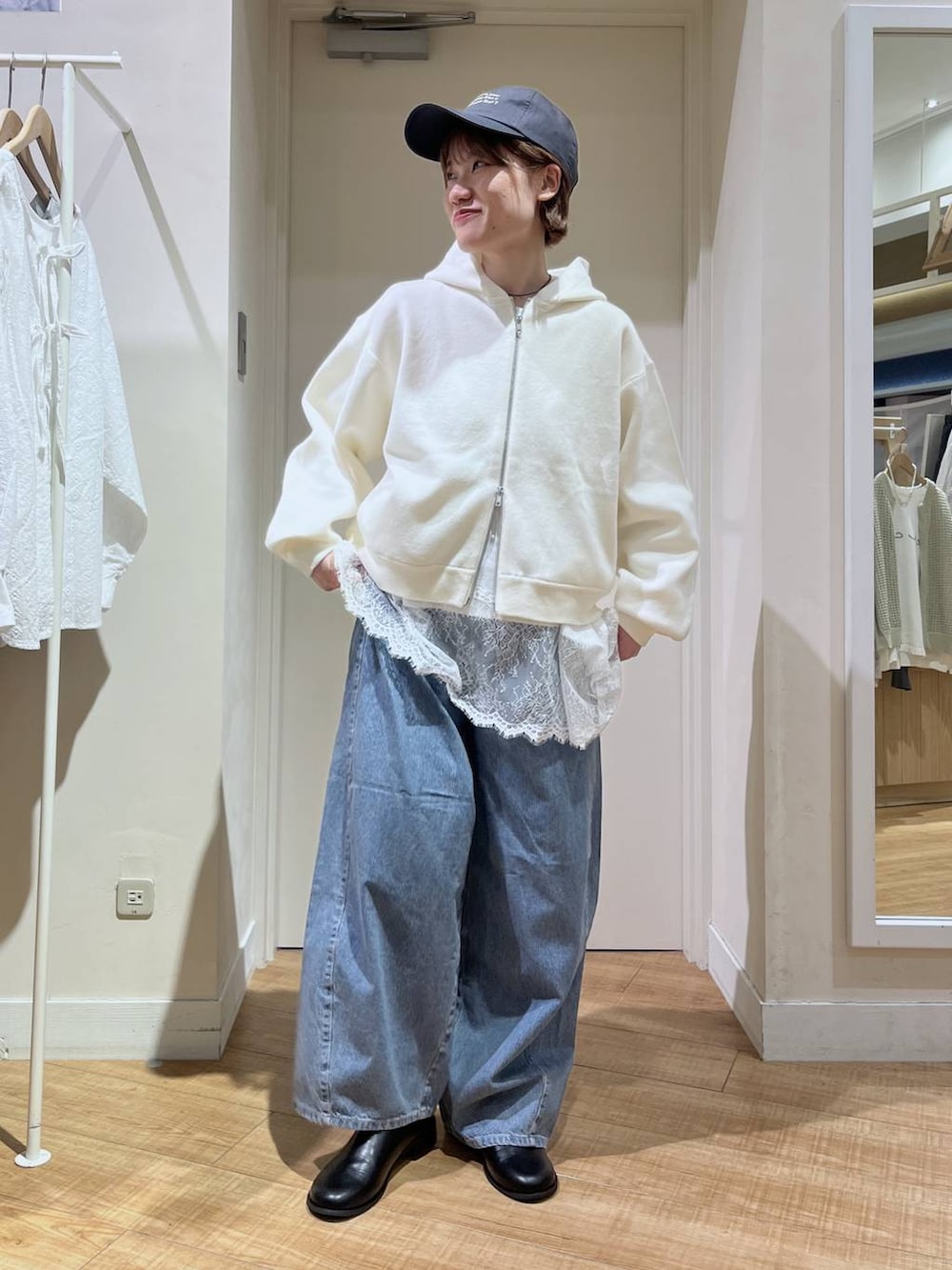 ブルー系のデニムパンツ、ホワイト系のパーカー、ホワイト系のTシャツ/カットソーを着用したレディースの春コーディネートの3枚目の写真