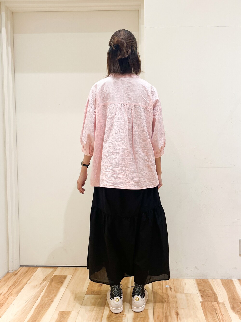 ピンク系のシャツ/ブラウス、ブラック系のスカートを着用したレディースの夏コーディネートの2枚目の写真