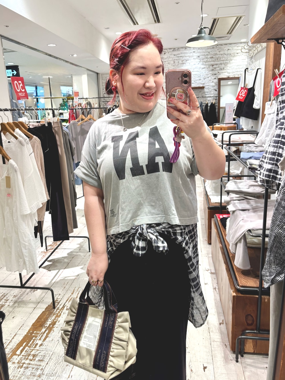 ベージュ系のショルダーバッグ、レッド系のスニーカー、グレー系のTシャツ/カットソーを着用したレディースの夏コーディネートの4枚目の写真