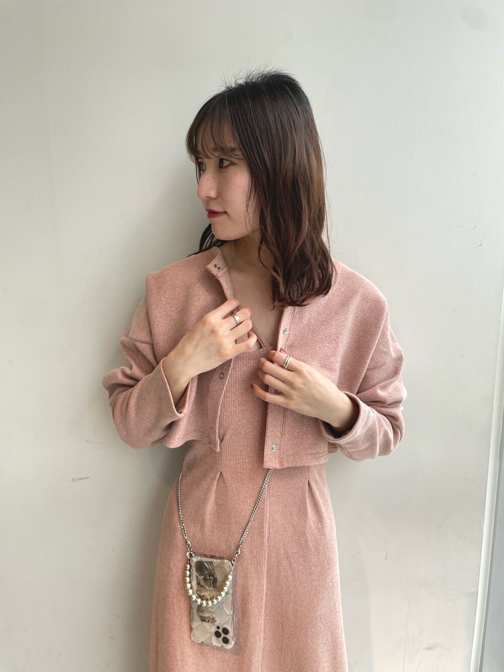 オレンジ系のワンピース、ホワイト系のサンダル、その他のスマホケース/カバーを着用したレディースの春コーディネートの2枚目の写真