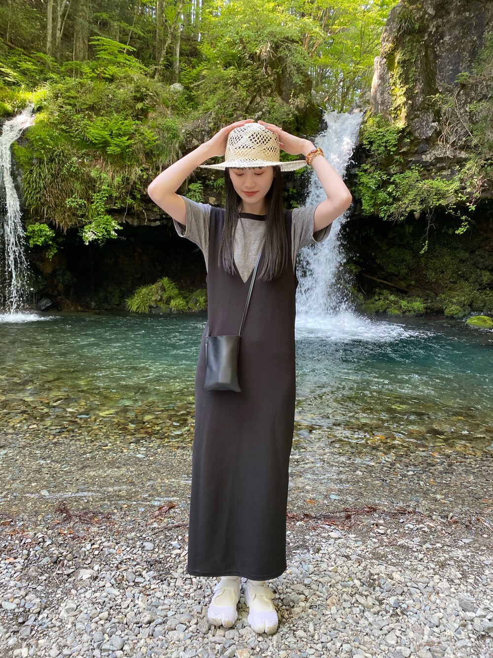 ブラック系のTシャツ/カットソー、ベージュ系の帽子を着用したレディースの春コーディネートの2枚目の写真