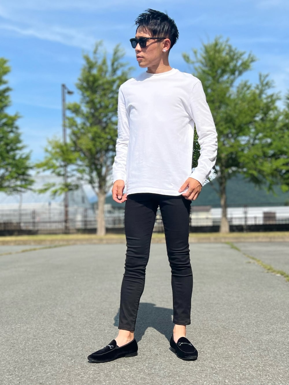 ホワイト系のTシャツ/カットソー、ブラック系のデニムパンツ、ブラック系のローファーを着用したメンズの夏コーディネートの3枚目の写真