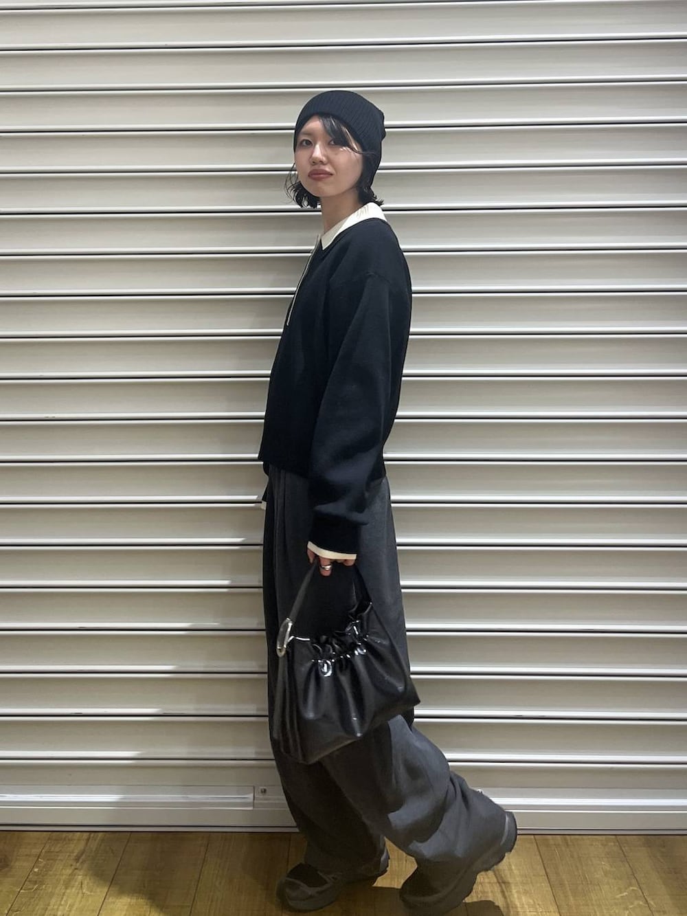 ブラック系のショルダーバッグ、ブラック系のニット/セーターを着用したレディースの冬コーディネートの2枚目の写真