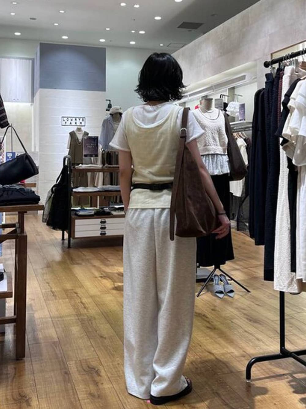 ブラウン系のショルダーバッグ、グレー系のスウェットパンツ、ブラック系のボディバッグ/ウエストポーチを着用したレディースの夏コーディネートの3枚目の写真