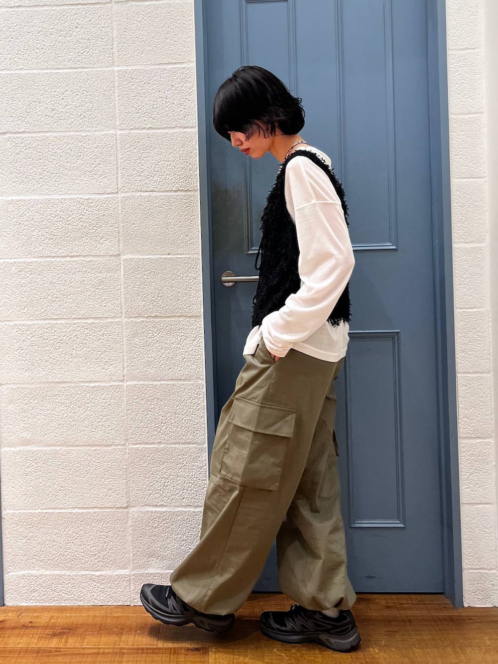ホワイト系のTシャツ/カットソー、グリーン系のカーゴパンツ、ブラック系のベストを着用したレディースの春コーディネートの2枚目の写真