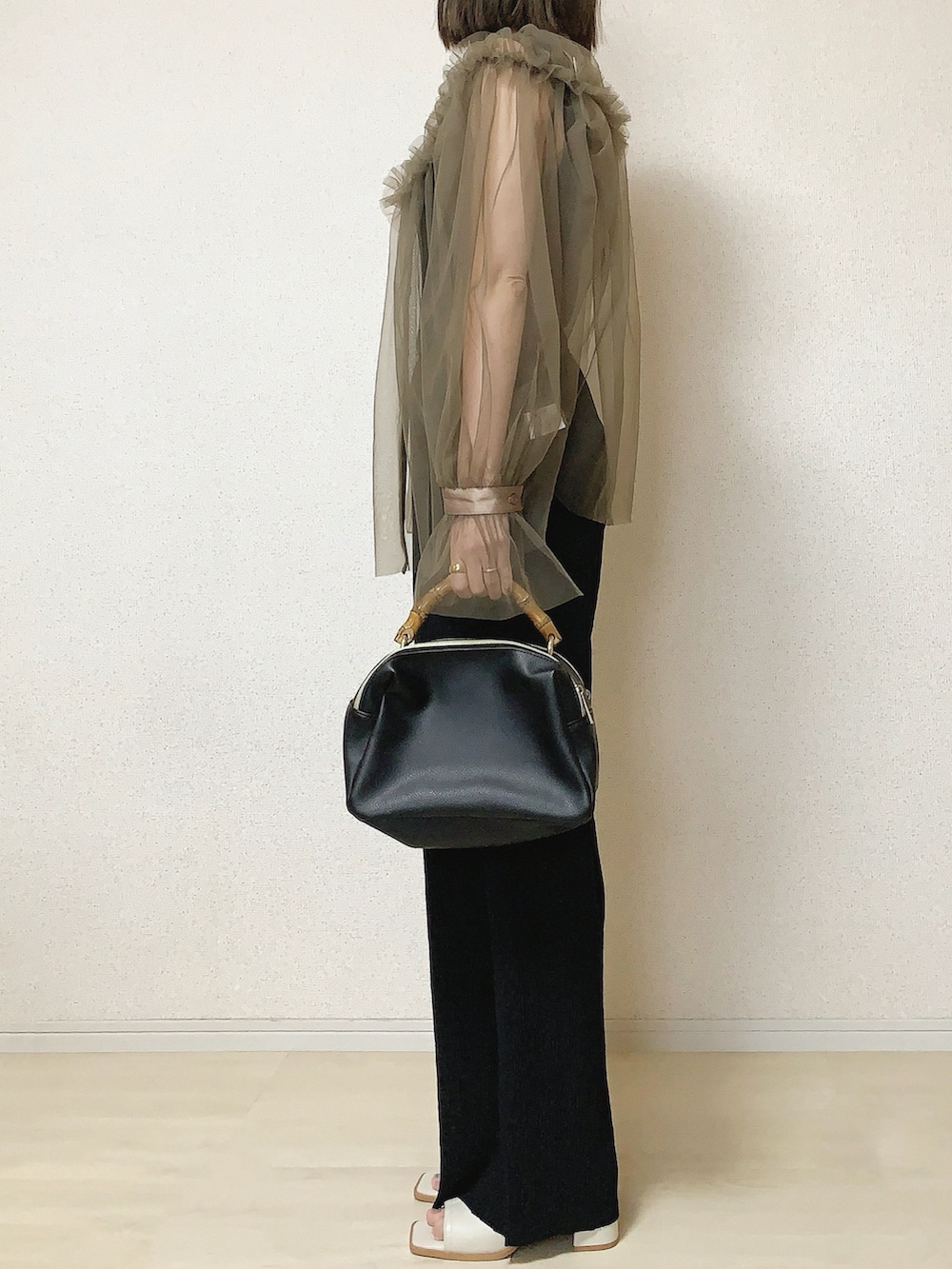 ブラック系のその他パンツ、ベージュ系のシャツ/ブラウスを着用したレディースの春コーディネートの3枚目の写真